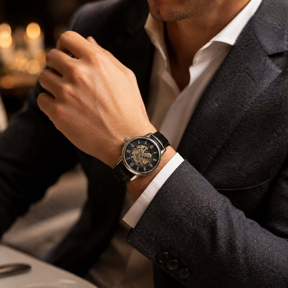 Man wearing a stylish automatic skeleton boyfriend watch gift with a black leather band.