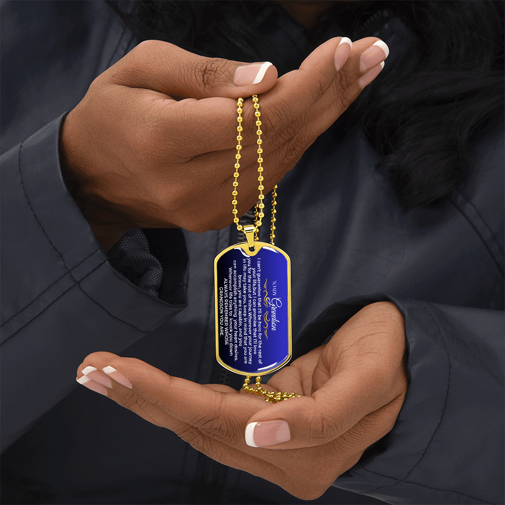 A person holding a blue liquid glass love tag necklace, a sentimental grandparent appreciation love tag keepsake for their grandson.