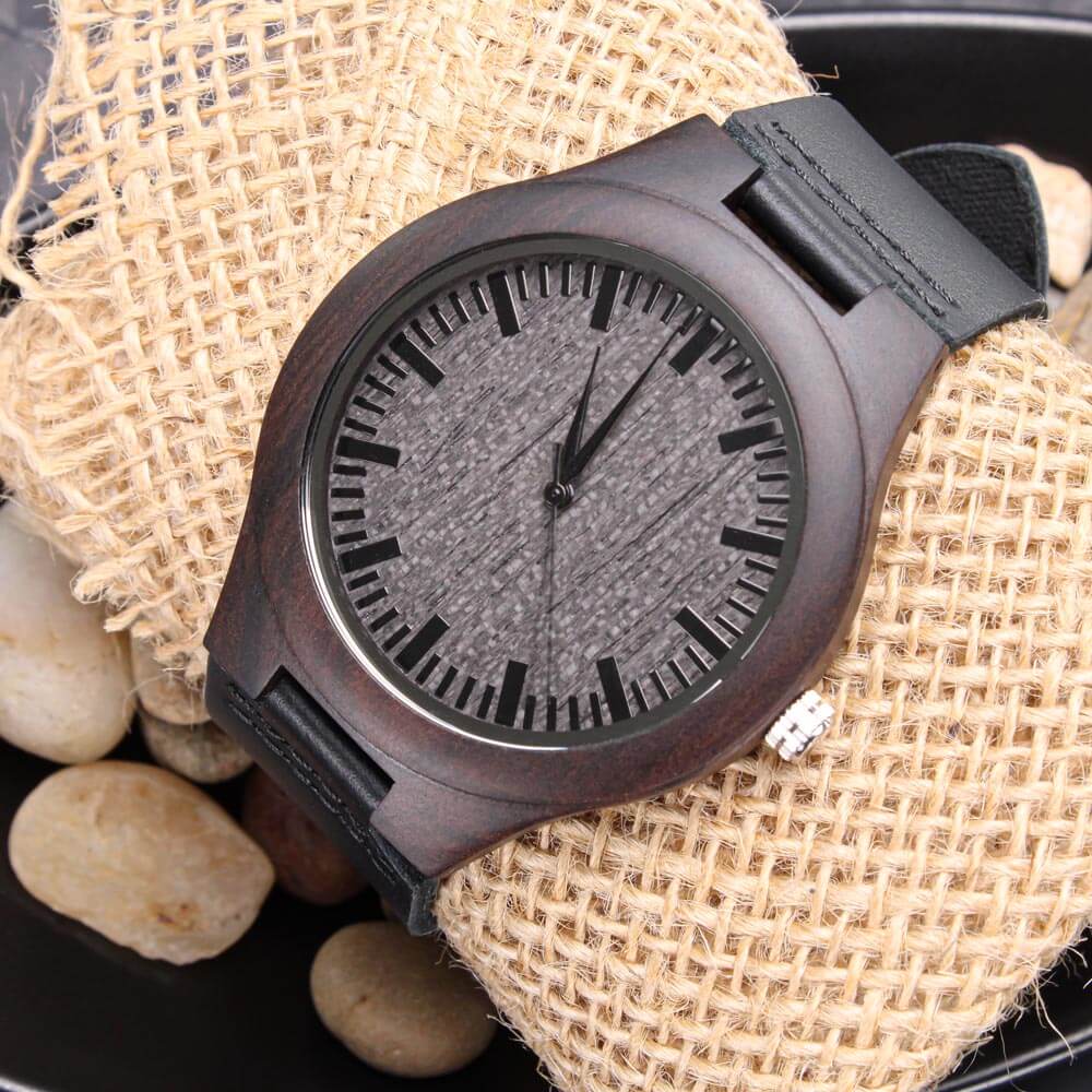Sentimental adult brother engraved wooden watch resting on burlap with pebbles, showcasing its unique organic style.
