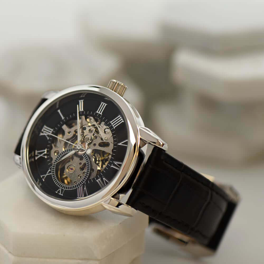 Automatic skeleton boyfriend watch gift with intricate dial and black leather band, showcasing elegant craftsmanship.