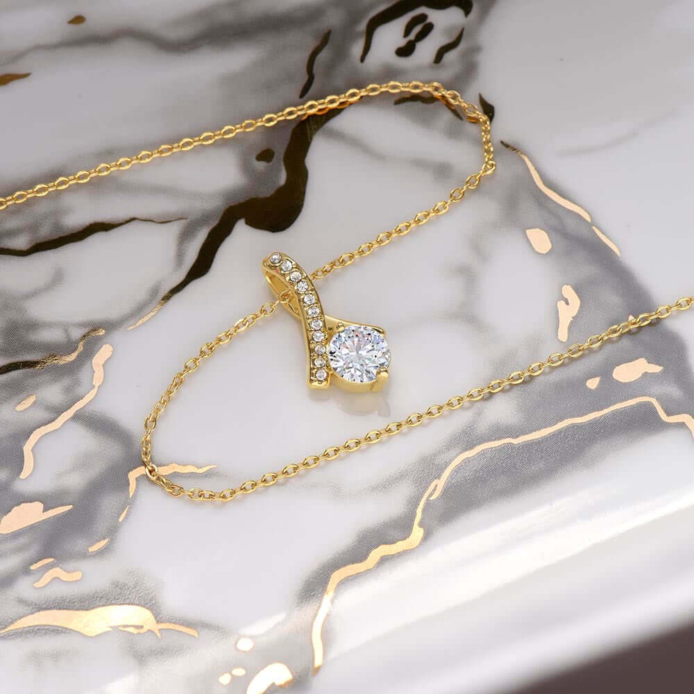 Meaningful valentine day or anniversary necklace for my wife featuring a ribbon pendant and diamond accents.