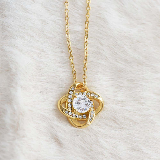 Interlocking knot keepsake milestone gift for her, featuring a gold necklace with a sparkling crystal.