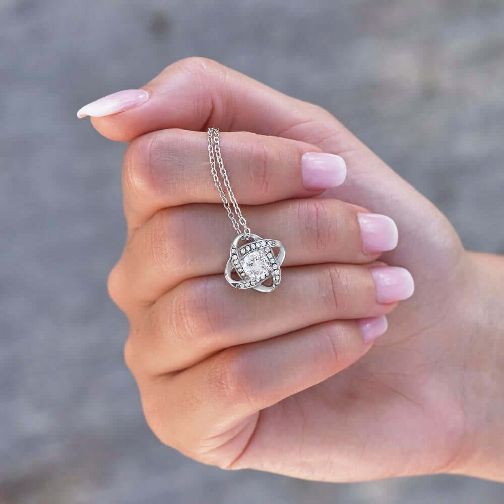 Gift For Mom set featuring a stunning silver necklace held in a hand with elegant nails.