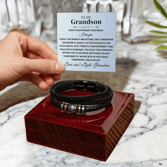 Grandson braided leather keepsake graduation milestone gift with heartfelt card resting on a wooden box.