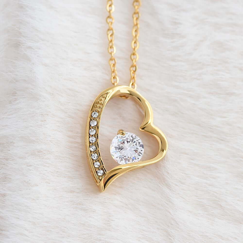 Sentimental Keepsake Jewelry for Daughter - Gold heart necklace with crystal centerpiece on soft background.