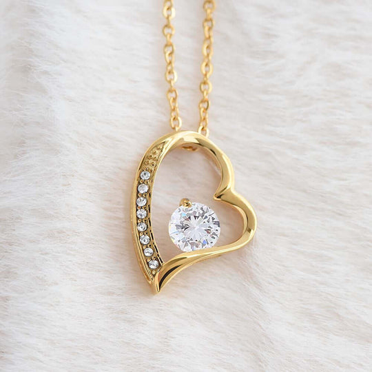 Sentimental Keepsake Jewelry for Daughter - Gold heart necklace with crystal centerpiece on soft background.