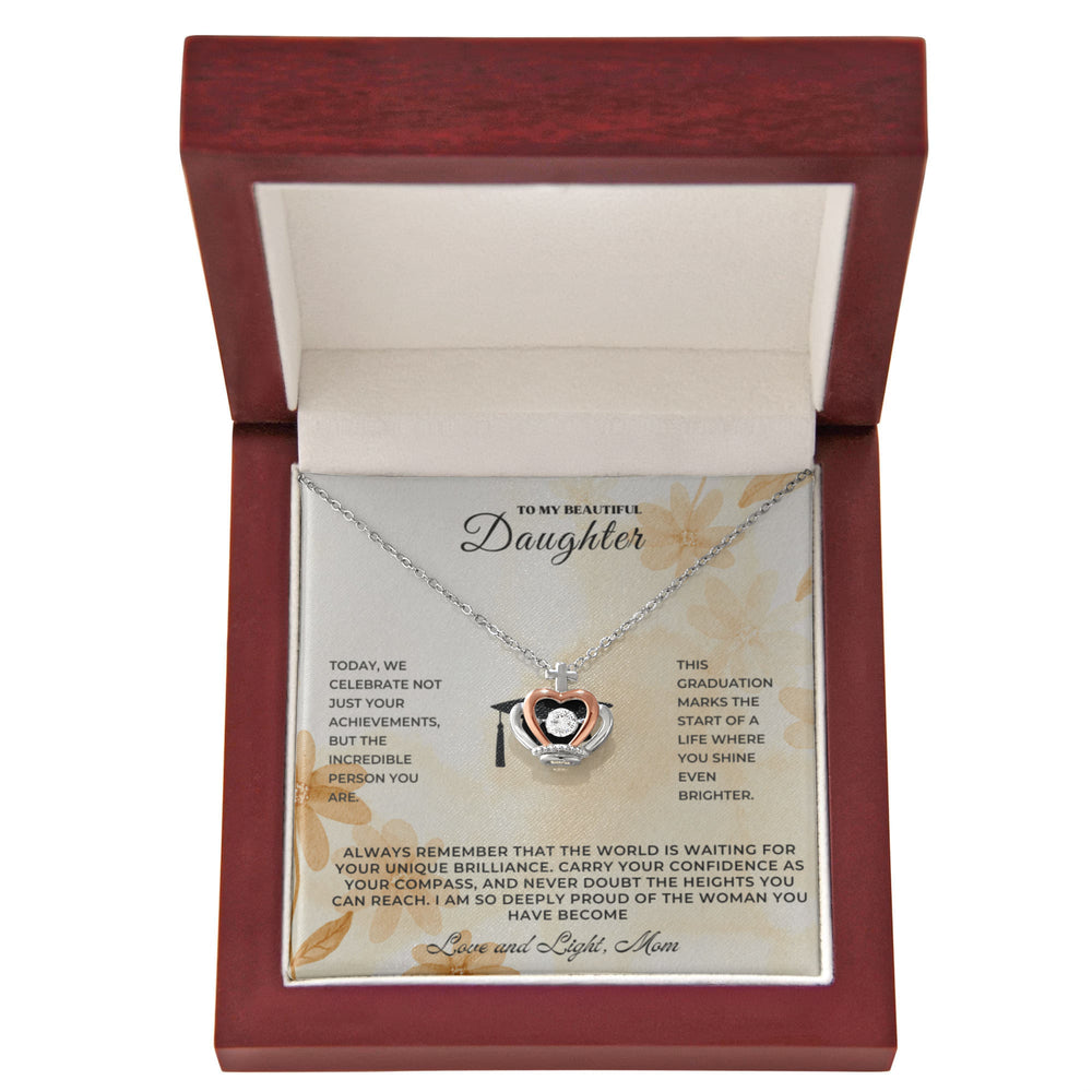 Sentimental keepsake jewelry for daughter in a decorative box, celebrating her graduation achievement.